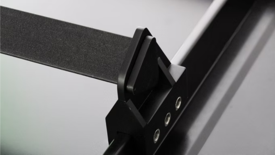 Universal Clamp locked onto a standing seam holding a snow rail